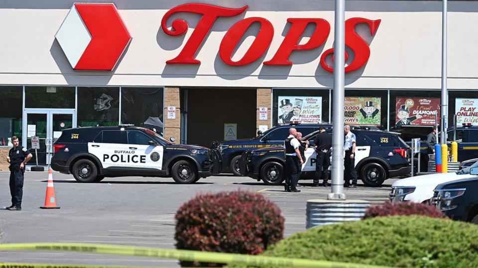 PHOTO: In this May 15, 2022, file photo, police sit in front of a Tops Grocery store in Buffalo, New York. (Usman Khan/AFP via Getty Images, FILE)