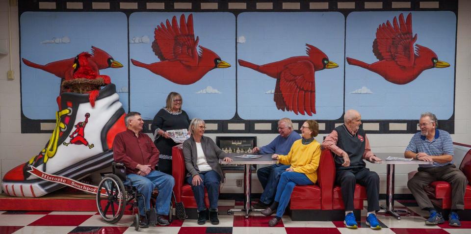 From left, staff members Bob White, publisher Kelly Sawyers, Jeanne Piersall, Denise Summers, Fred Shonk, Al Stilley and Steve Page, of The Southsider Voice weekly newspaper, gather Tuesday, Jan. 24, 2023, inside the Cardinals Nest hospitality room at Southport High School. Summers helped Sawyer establish the paper in 2009. "We are 100% good news," Stilley said. "Kelly has just a huge passion to do this weekly newspaper and to make it a good news newspaper."