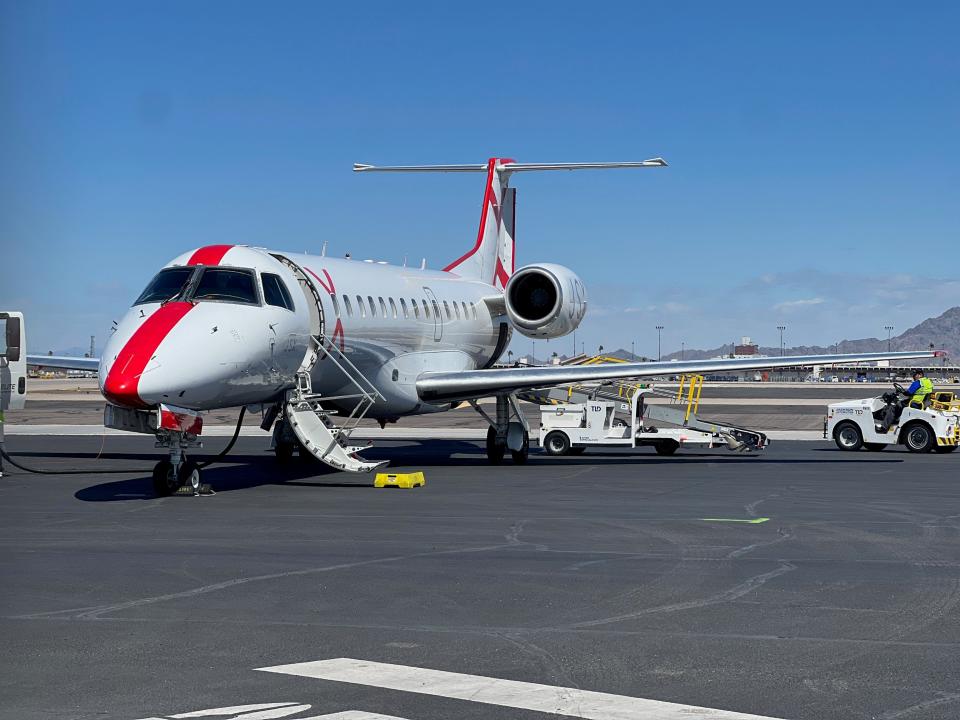 A JSX aircraft with its passenger loading door open after landing in Phoenix.