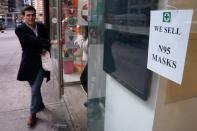 A man walks out of a pharmacy after purchasing N95 face masks in advance of the potential coronavirus outbreak in the Manhattan borough of New York City