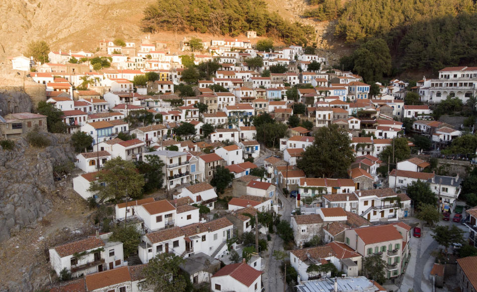 In this Sept. 8, 2019, photo, aerial photo Chora village is seen on Samothraki island, northeastern Greece. Goat herding is a way of life on Samothraki, a hard-to-reach Greek island in the northern Aegean Sea, but experts and locals are working together to control the animal population that has left its mountains barren and islanders under the threat of mudslides. (AP Photo/Iliana Mier)