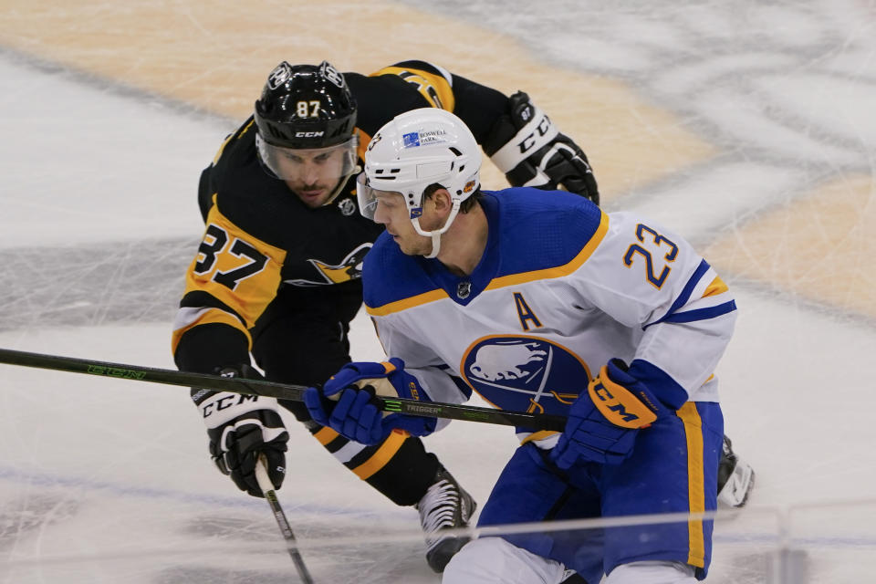 Pittsburgh Penguins' Sidney Crosby (87) chases Buffalo Sabres' Sam Reinhart (23) during the third period of an NHL hockey game, Thursday, March 25, 2021, in Pittsburgh. (AP Photo/Keith Srakocic)