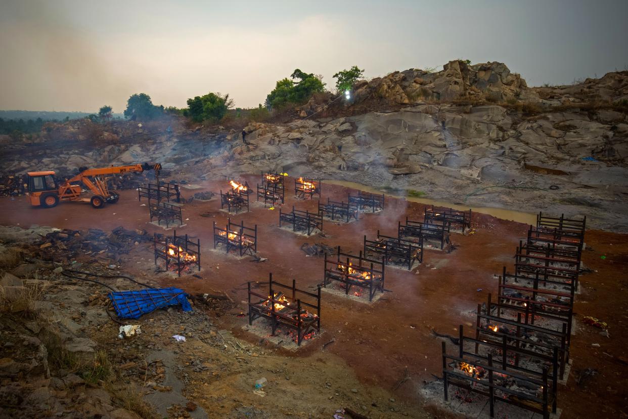 A crane places new biers in a disused granite quarry repurposed to cremate the dead due to COVID-19 on April 30, 2021, in Bengaluru, India.