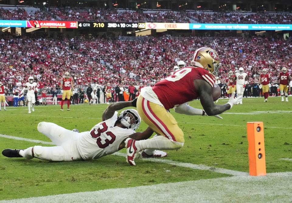 Dec 17, 2023; Glendale, Ariz, United States; San Francisco 49ers wide receiver Deebo Samuel (19) catches a touchdown while defended by Arizona Cardinals cornerback <a class="link " href="https://sports.yahoo.com/nfl/players/29957" data-i13n="sec:content-canvas;subsec:anchor_text;elm:context_link" data-ylk="slk:Antonio Hamilton;sec:content-canvas;subsec:anchor_text;elm:context_link;itc:0">Antonio Hamilton</a> Sr. (33) during the fourth quarter at State Farm Stadium.