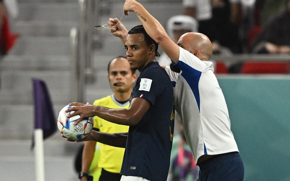 France's Jules Kounde has a necklace removed during the match - REUTERS