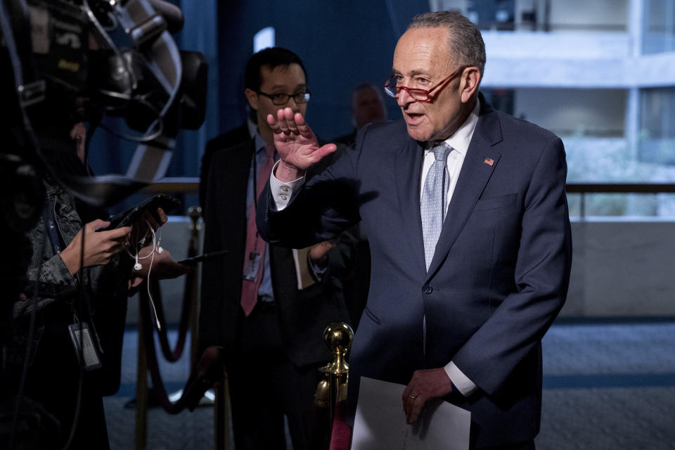 FILE - In this March 20, 2020, file photo Senate Minority Leader Sen. Chuck Schumer of N.Y., speaks to reporters as he arrives for a meeting to discuss the coronavirus relief bill on Capitol Hill Washington. The Trump administration and Congress are nearing an agreement as early as Sunday, April 19, on a $400-plus billion aid package to boost a small-business loan program that has run out of money and add funds for hospitals and COVID-19 testing. (AP Photo/Andrew Harnik, File)