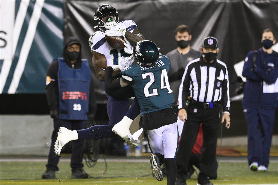 Seattle Seahawks' DK Metcalf (14) catches a pass against Philadelphia Eagles' Darius Slay (24) during the second half of an NFL football game, Monday, Nov. 30, 2020, in Philadelphia. (AP Photo/Derik Hamilton)