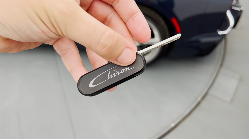 Doug DeMuro holding the Bugatti Chiron's top speed key