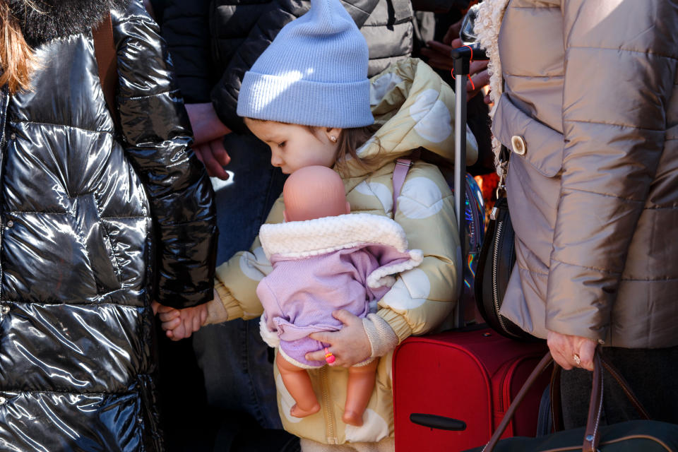 UZHHOROD, UKRAINE - FEBRUARY 27, 2022 - A little girl holding a woman's hand clutches a doll at the Uzhhorod-Vysne Nemecke checkpoint on the Ukraine-Slovakia border, Zakarpattia Region, western Ukraine. (Photo credit should read SerhiiHudak/ Ukrinform/Future Publishing via Getty Images)