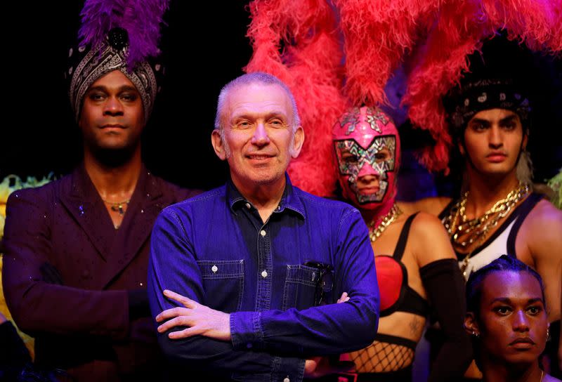 Designer Jean Paul Gaultier poses for a photograph with members of the cast of "Fashion Freak Show" prior to its opening at the Southbank Centre in London