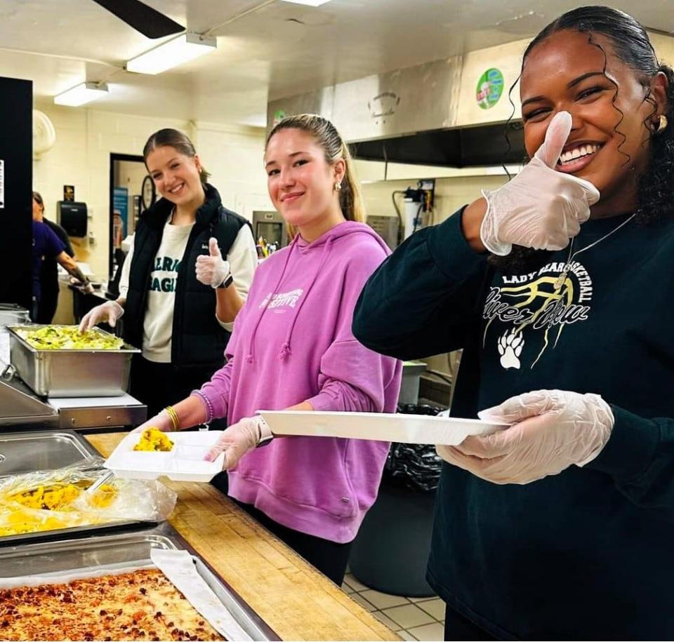 Antonia Werner, Jana Pallares and Chichi Onwunzo serve traditional Spanish food to students as part teaching about their cultures for their senior project at River View High School. Werner and Onwunzo are exchange students from Germany and Pallares is from Spain.