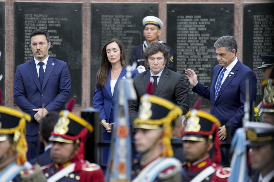 Argentine President Javier Milei, center, visits a war memorial at the official ceremony commemorating the 42nd anniversary of the conflict between Argentina and Great Britain over the Falkland Islands or Malvinas Islands in Buenos Aires, Argentina, Tuesday, April 2, 2024. (AP Photo/Natacha Pisarenko)