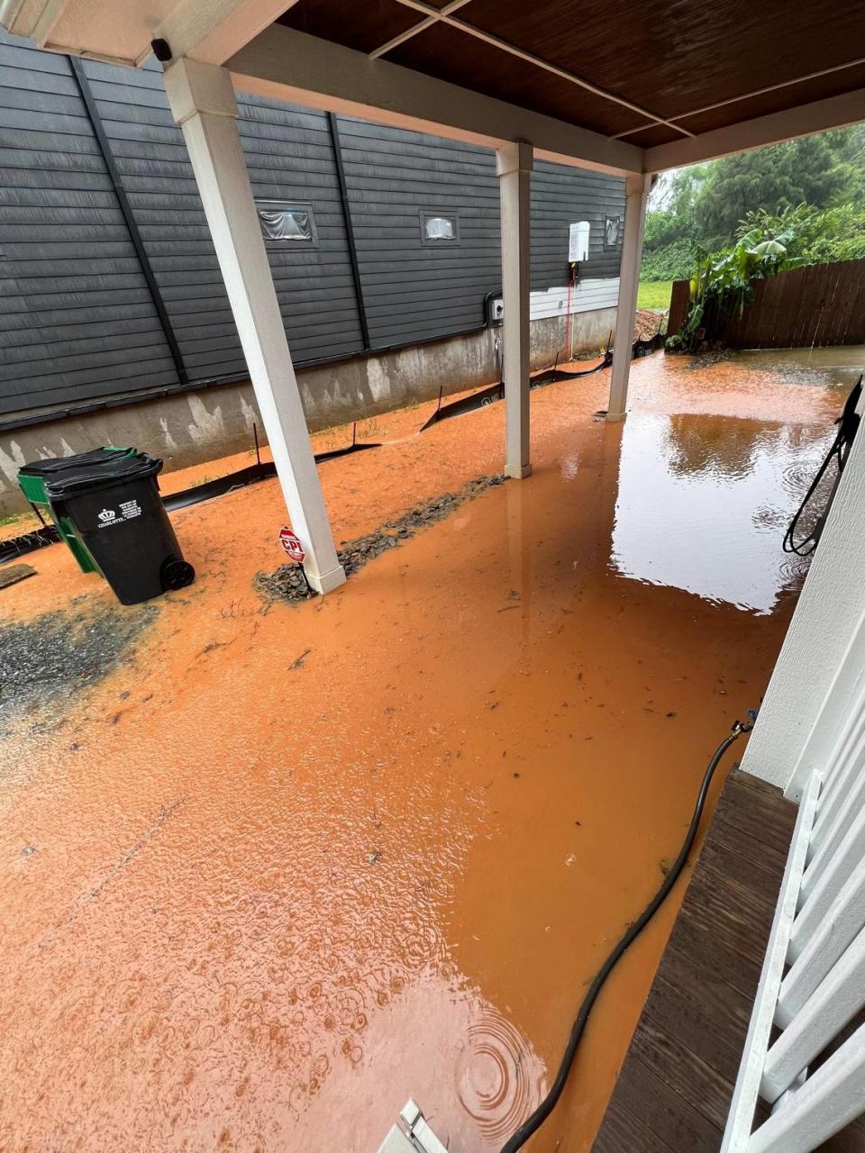 Flood water pools between newly built and existing homes along Coxe Avenue in Charlotte.