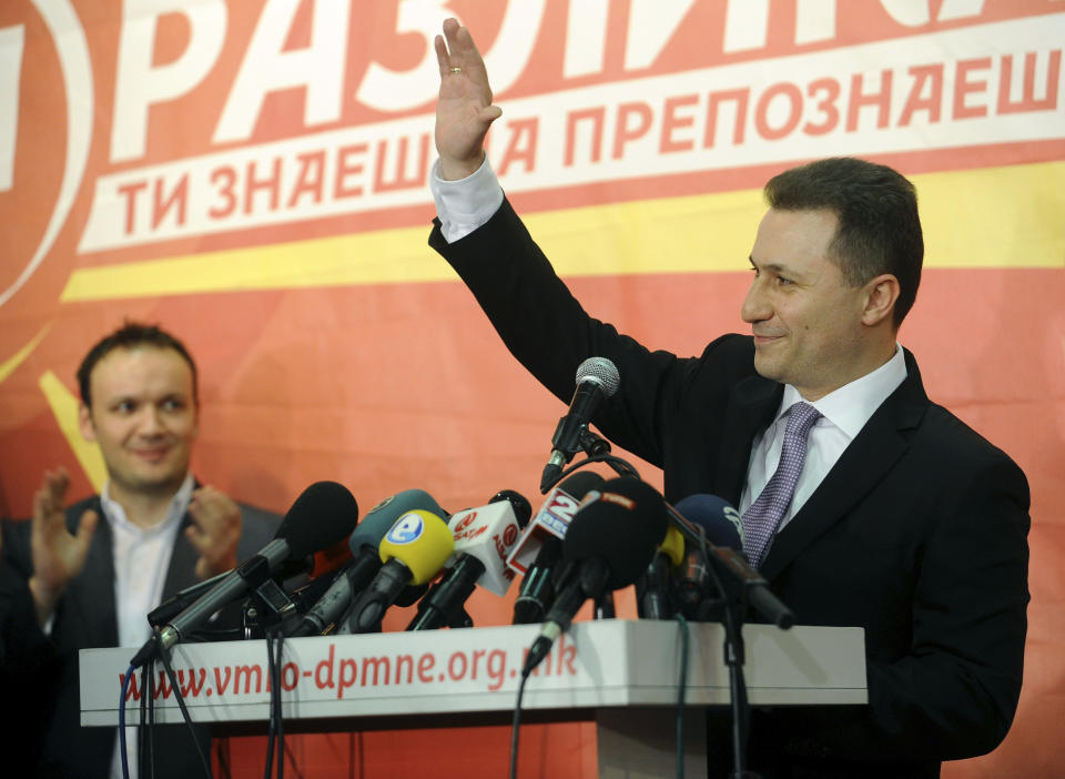 Macedonian Prime Minister and leader of the ruling conservative VMRO-DPMNE Nikola Gruevski greets his supporters while announcing a double victory in parliamentary and presidential elections, in Skopje, Macedonia, early Monday, April 28, 2014. Macedonia's incumbent prime minister claimed a landslide victory late Sunday in parliamentary and presidential elections, but the center-left opposition denounced what it called distorting interference in the democratic process by the ruling party and said it won't recognize the results. (AP Photo/Boris Grdanoski)