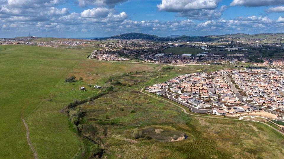 Newly built homes stand in El Dorado Hills last month near land owned by Angelo Tsakopoulos that is proposed for development.