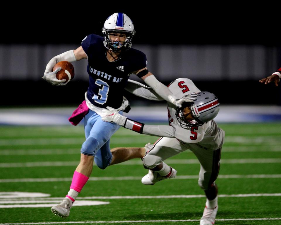 CCDS running back Ashton Snell gives a stiff arm to Deer Park defensive back Kevin Guzman and gets extra yardage in the game between Deer Park and CCD High School Oct. 30, 2021.