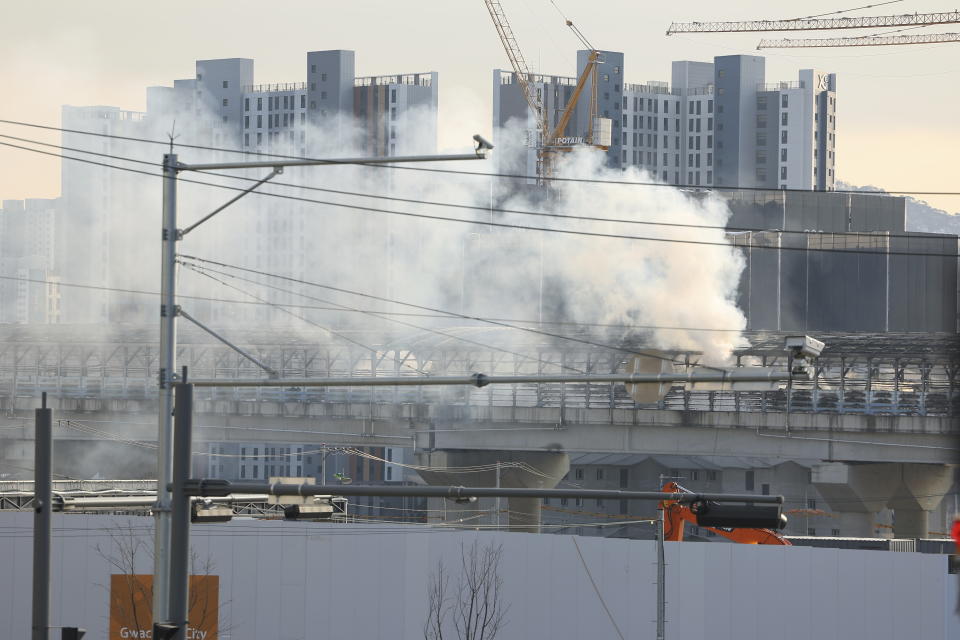 Smoke rises at the scene of a fire in Gwacheon, South Korea, Thursday, Dec. 29, 2022. A freight truck collided with a bus on a highway near Seoul on Thursday, causing a fire that killed multiple people and injuring dozens of others, officials said. (Kim Do-hun/Yonhap via AP)