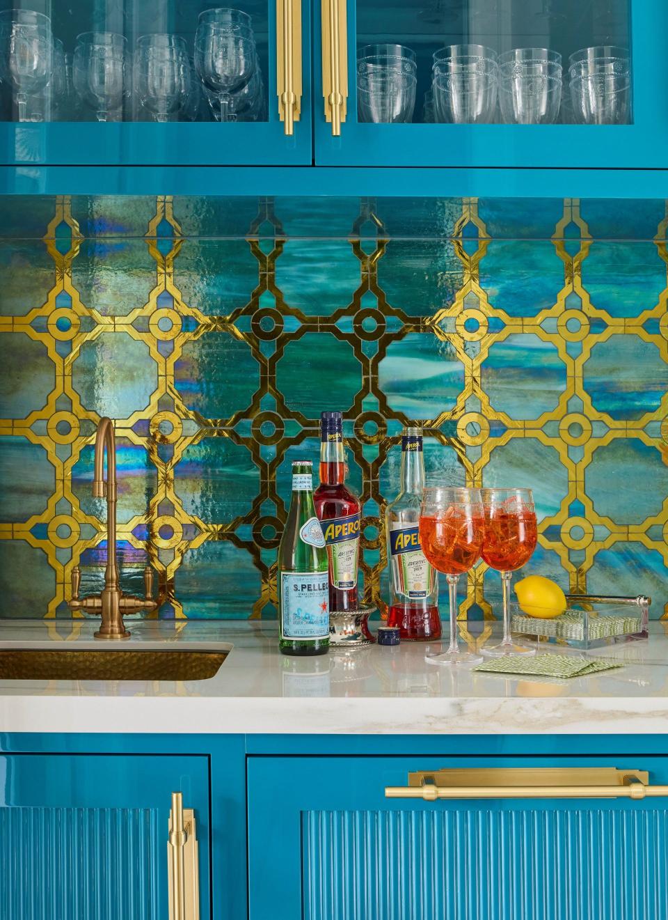 This bar inside a newly decorated Palm Beach home features custom backsplash tile and millwork designed by Alexandra Naranjo.