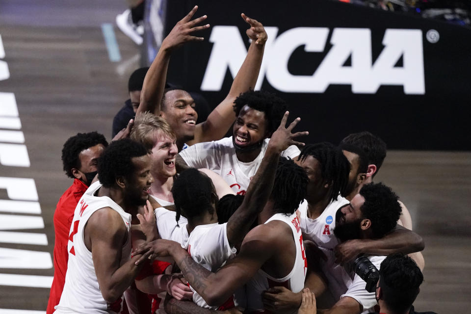 Houston players celebrate after beating Houston 67-61 during an Elite 8 game in the NCAA men's college basketball tournament at Lucas Oil Stadium, Monday, March 29, 2021, in Indianapolis. (AP Photo/Michael Conroy)