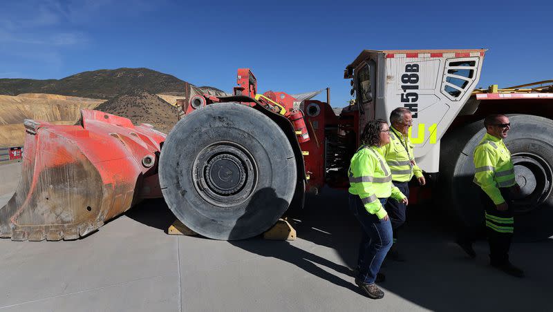 Rio Tinto employees walk past a battery-operated underground mining load haul dump loader at the Kennecott Copper Mine near Herriman on Tuesday, Sept. 27, 2022.