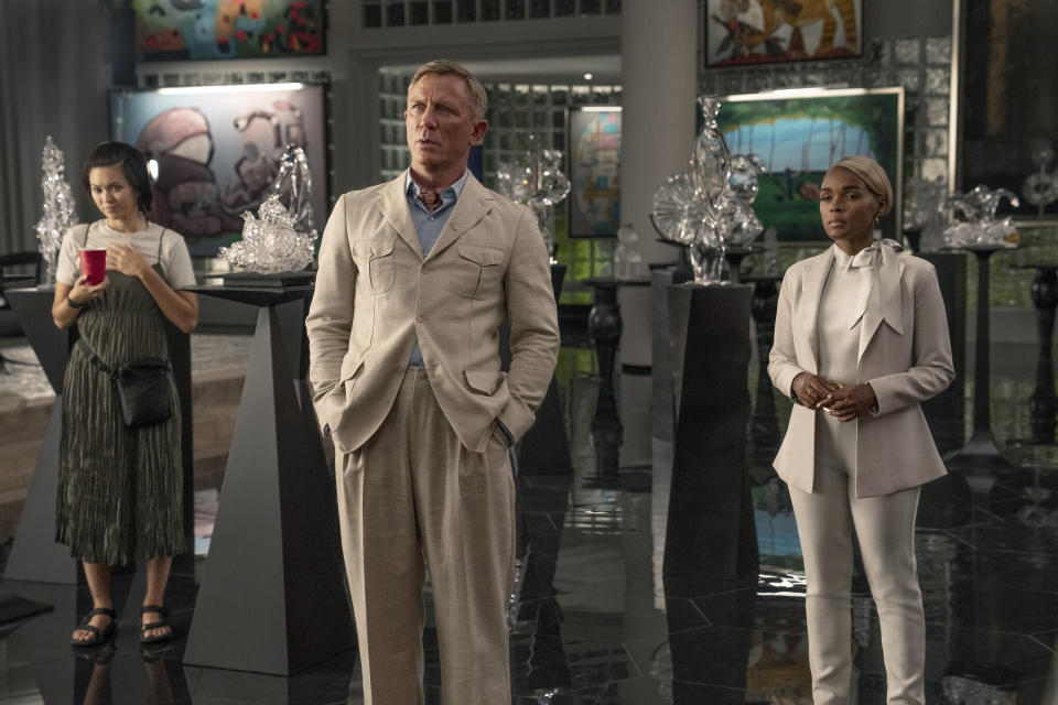 This image released by Netflix shows Jessica Henwick, left, Daniel Craig, center, and Janelle Monáe in a scene from "Glass Onion: A Knives Out Mystery." (John Wilson/Netflix via AP)