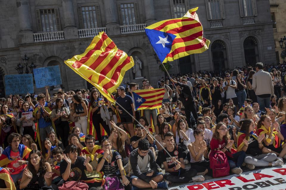 Students protest in Sant Jaume square in Barcelona, Spain, Thursday, Oct. 17, 2019. Catalonia's separatist leader vowed Thursday to hold a new vote to secede from Spain in less than two years as the embattled northeastern region grapples with a wave of violence that has tarnished a movement proud of its peaceful activism. Thousands of people have also been marching peacefully since Wednesday toward the regional capital, Barcelona. Students are on strike, and trade unions are planning to join them on Friday. (AP Photo/Bernat Armangue)