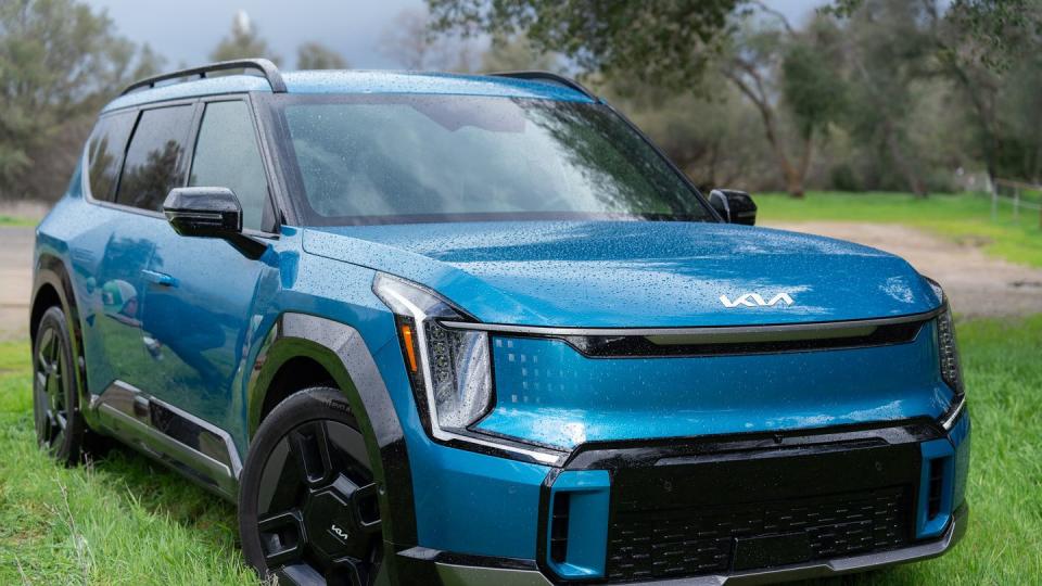 a blue car parked on grass