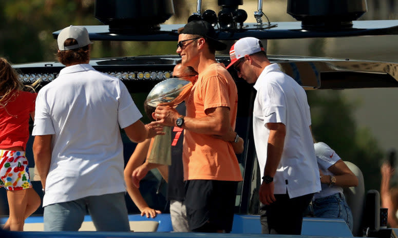 Tampa Bay Buccaneers QB Tom Brady holding the Lombardi Trophy at the Super Bowl parade.