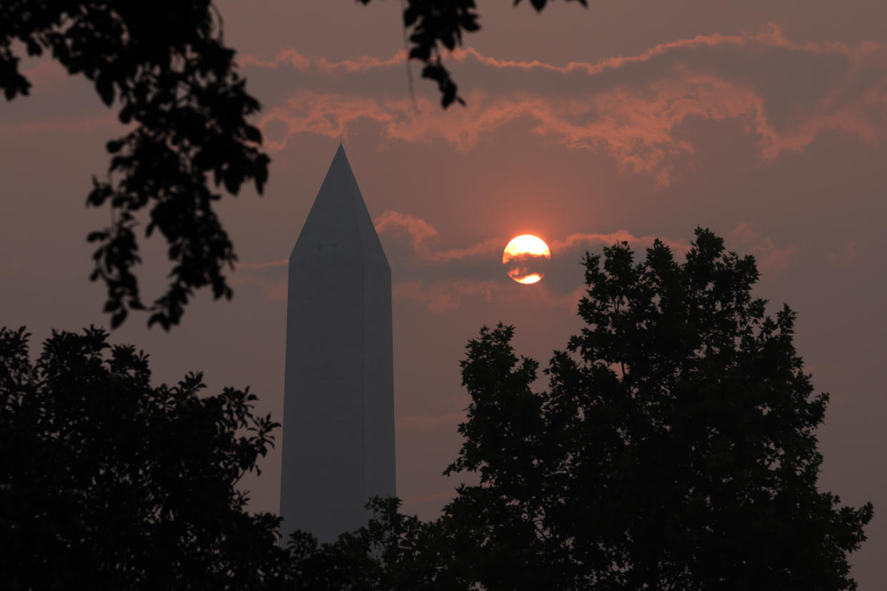 The Washington Memorial stands in hazy smoke.