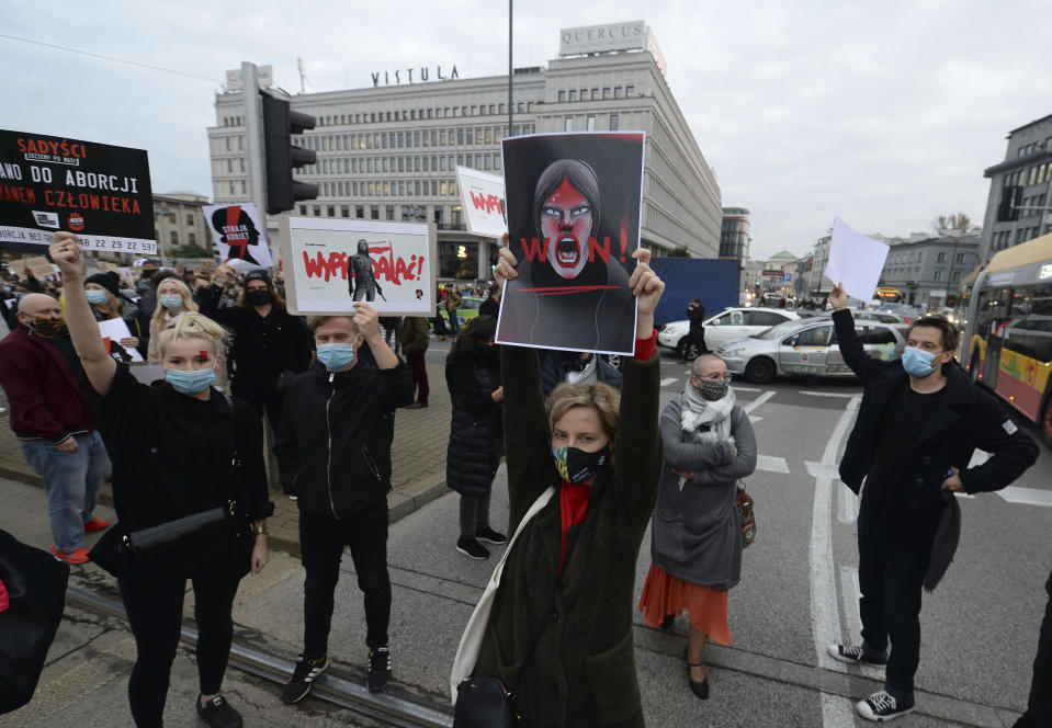 Angered protesters block rush-hour traffic at a major roundabout on the fifth day of nationwide protests against recent court ruling that tightened further Poland's restrictive abortion law, in Warsaw, Poland, on Monday, Oct. 26, 2020. The court effectively banned almost all abortions. (AP Photo/Czarek Sokolowski)