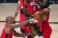 Oklahoma City Thunder's Dennis Schroder (17) has his shot attempt blocked by the combined defense of Houston Rockets' P.J. Tucker, left, and James Harden, right, during the second half of an NBA first-round playoff basketball game, Monday, Aug. 31, 2020, in Lake Buena Vista, Fla. (AP Photo/Mark J. Terrill)