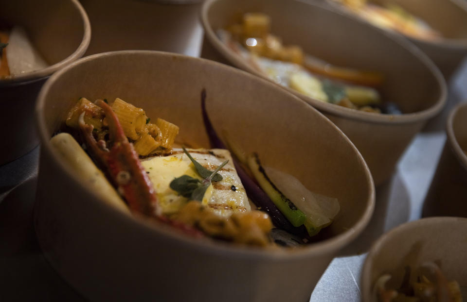 A dish containing Turbot, langoustine, tubetti pasta, nduja, Zeeland mussels and crustaceans waits for its finishing touches as part of nearly 600 take-away orders at Sergio Herman's Le Pristine restaurant in Antwerp, Belgium, Saturday, Nov. 7, 2020. Of all the many challenges the pandemic throws up for all kinds of professions, this one has been particularly tough: How to put a three-star chef into a takeout box. (AP Photo/Virginia Mayo)