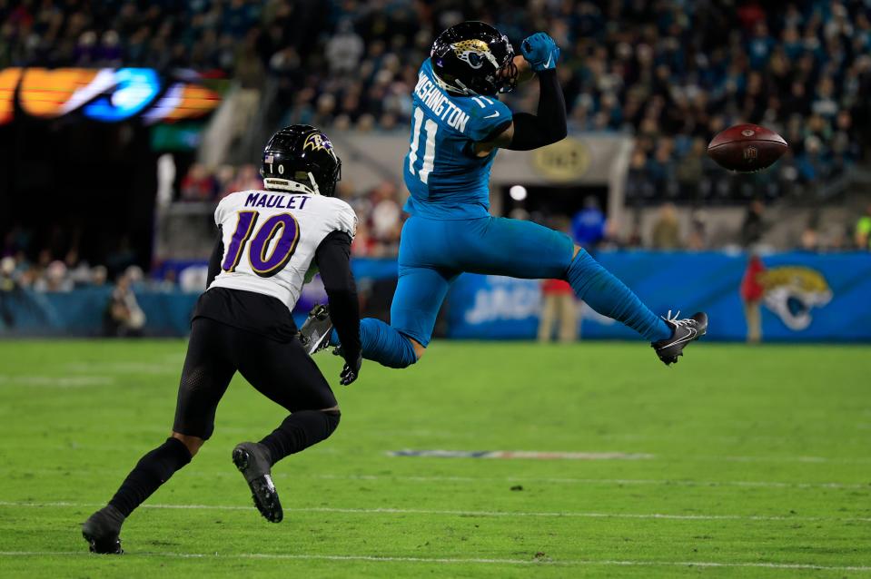 Jacksonville Jaguars wide receiver Parker Washington (11) can’t haul in a reception against Baltimore Ravens cornerback Arthur Maulet (10) during the second quarter of a regular season NFL football matchup Sunday, Dec. 17, 2023 at EverBank Stadium in Jacksonville, Fla. The Baltimore Ravens defeated the Jacksonville Jaguars 23-7. [Corey Perrine/Florida Times-Union]