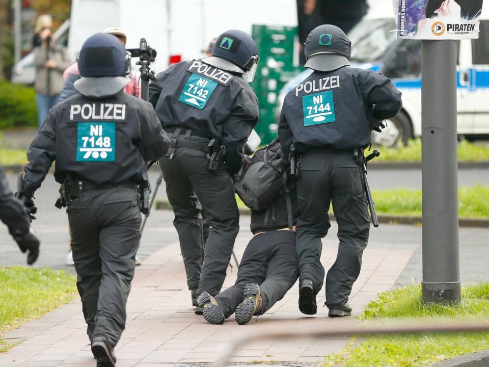 Police arrest an activist during a demonstration against anti-immigration party the Alternative for Germany (AfD) before the party's conference in Cologne on 22 April (Reuters)