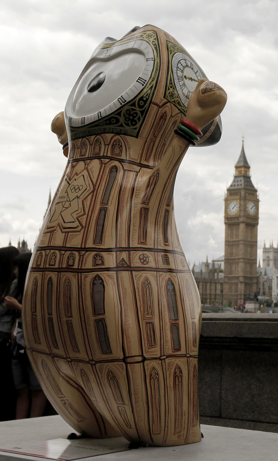 An Olympic mascot, painted in the likeness of Big Ben, is displayed across the River Thames from the actual Big Ben on Saturday, July 21, 2012, in London. The statue is one of 84 fiberglass sculptures of the mascots Wenlock or Mandeville that were painted by various artists and erected across the city for the 2012 London Olympic Games. (AP Photo/Charlie Riedel)