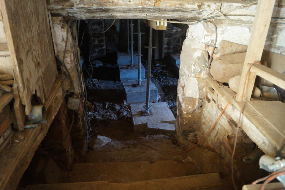 Stairs from the main room lead to a cellar that once had a stream running through it. (Photo: Michael Walsh/Yahoo News)