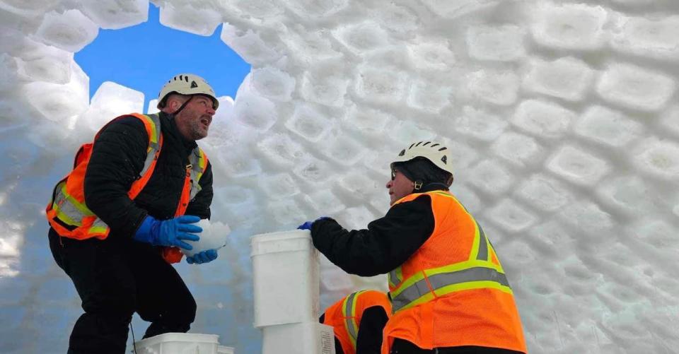 Eric Ouellette, left, of Grand Falls created what he expects to be a world-record breaking ice dome at the 2024 Winter Carnaval in Quebec City.