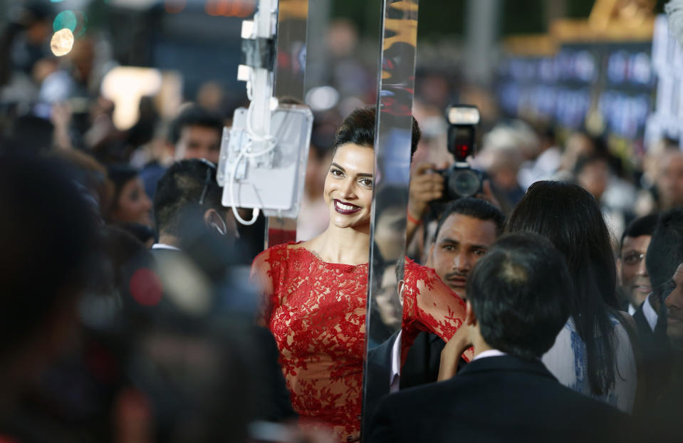 Indian film star Deepika Padukone walks the green carpet as she arrives for the 15th annual International Indian Film Awards on Saturday, April 26, 2014, in Tampa, Fla. (AP Photo/Brian Blanco)