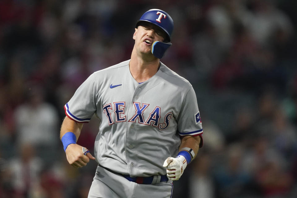 Texas Rangers' Josh Jung reacts while running to first after flying out to Los Angeles Angels left fielder Randal Grichuk during the third inning of a baseball game, Monday, Sept. 25, 2023, in Anaheim, Calif. (AP Photo/Ryan S. Sun)