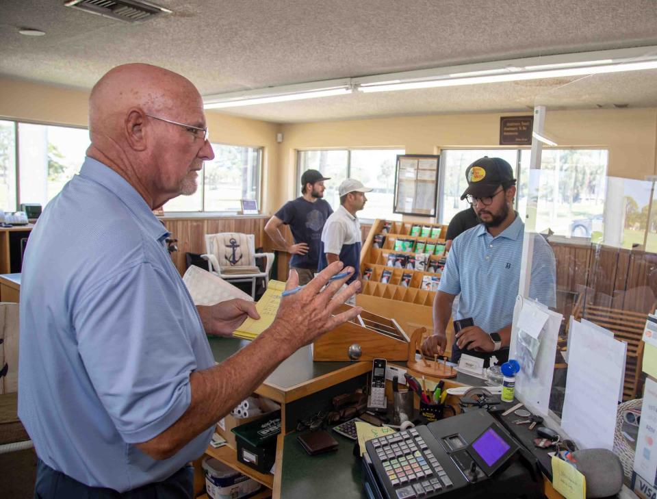 Jeff Simke, left, who began playing the Lone Pine Golf Course 45 years ago and now works behind the counter in the clubhouse, talks to golfers who have come to play a round of golf on Sunday, April 16, 2023, the last day the club will be open.