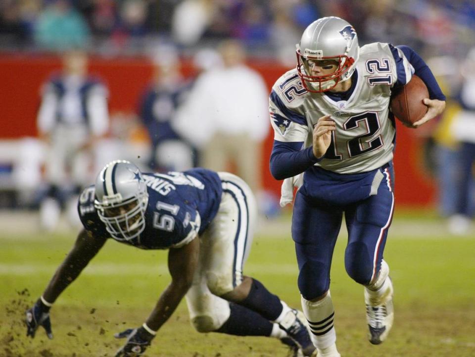 New England quarterback Tom Brady scrambles around Cowboys Al Singleton, in the fourth quater against the Dallas Cowboys at Gillete Stadium in Foxborough, Mass., on Oct. 16, 2003.