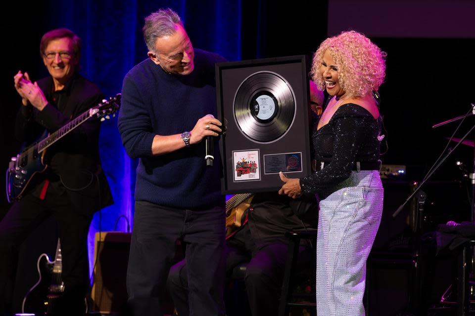 Bruce Springsteen presents Darlene Love with a platinum album plaque for "A Christmas Gift for You from Phil Spector," the 1963 album that includes Love's classic, "Christmas (Baby Please Come Home)" on Nov. 30 at Town Hall in New York.