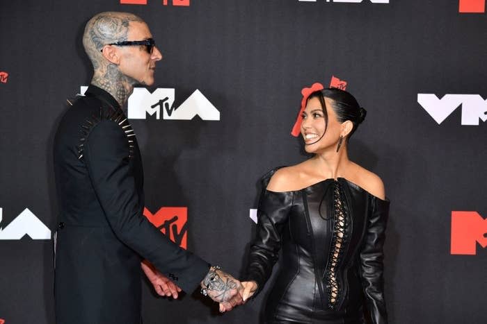 Travis Barker and Kourtney Kardashian hold hands as they arrive for the 2021 MTV Video Music Awards