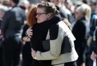 Friends hug after the funeral of Josh Hunter in Calgary, Alberta, April 21, 2014. Matthew de Grood is charged with killing Hunter and four of his friends at a house party in Calgary's worst mass murder in the history of the city, according to local media reports. REUTERS/Todd Korol (CANADA - Tags: CRIME LAW OBITUARY)