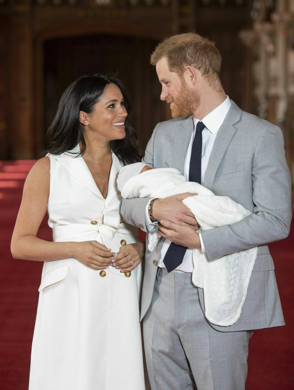 Britain's Prince Harry and Meghan, Duchess of Sussex, during a photocall with their newborn son, in St George's Hall at Windsor Castle, Windsor, south England, Wednesday May 8, 2019. Baby Sussex was born Monday at 5:26 a.m. (0426 GMT; 12:26 a.m. EDT) at an as-yet-undisclosed location. An overjoyed Harry said he and Meghan are "thinking" about names. (Dominic Lipinski/Pool via AP)