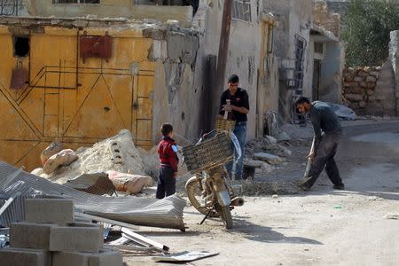 Residents work on fixing a house in the town of Darat Izza, province of Aleppo, Syria February 28, 2016. REUTERS/Ammar Abdullah