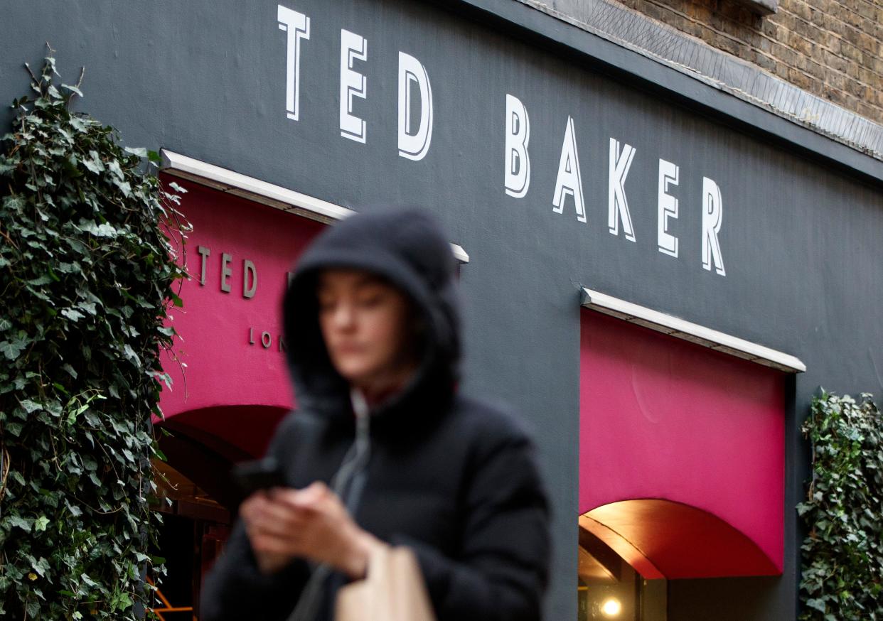 Pedestrians walk past a Ted Baker clothing store in London on December 10, 2019. - British fashion brand Ted Baker on Tuesday said both its top bosses had quit, as it warned on profits and suspended its dividend on weak consumer spending amid economic uncertainties. The group has replaced chief executive Lindsay Page with finance director Rachel Osborne on an interim basis less than a year after Page taking charge. (Photo by Tolga Akmen / AFP) (Photo by TOLGA AKMEN/AFP via Getty Images)