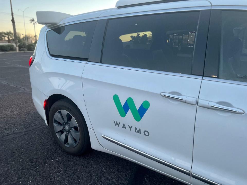 The white Waymo self-driving car.
