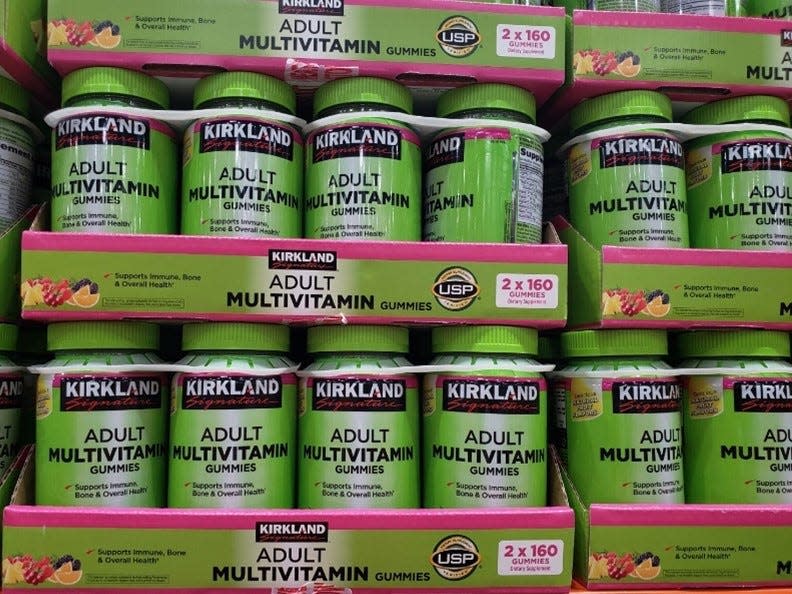 stack of green containers of kirkland's multivitamins at costco