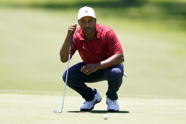 Harold Varner III lines up his putt on the 18th green during the first round of the Charles Schwab Challenge golf tournament at the Colonial Country Club, Thursday, May 26, 2022, in Fort Worth, Texas. (AP Photo/Tony Gutierrez)